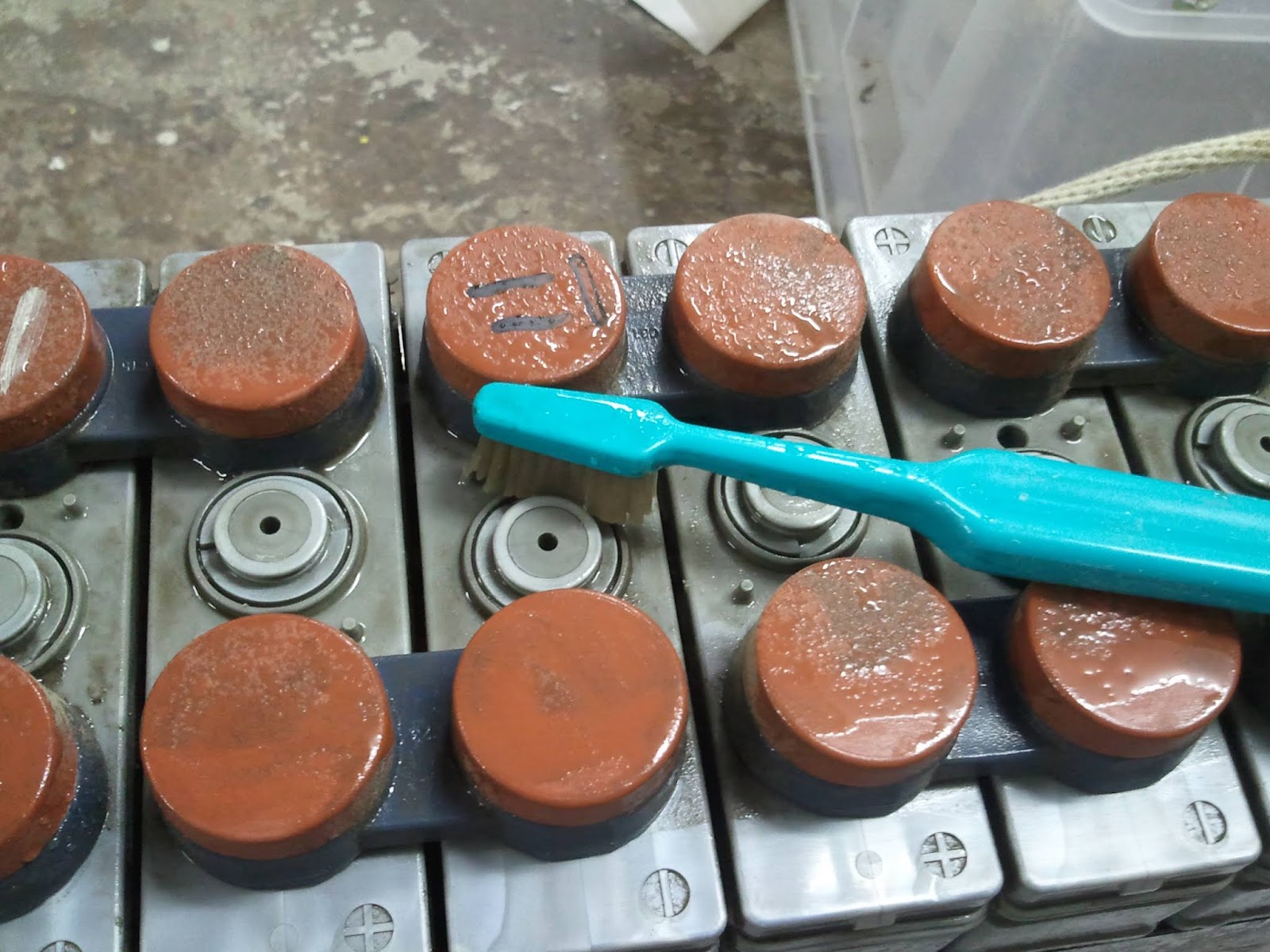 Using old toothbrush to work the boric acid solution on all corners